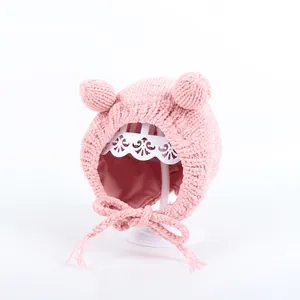 Detailed view of pink baby knit hat featuring cute bear ears and chenille straps