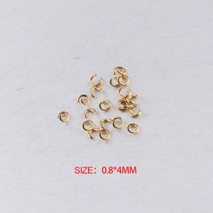 Golden 0.8x4mm stainless steel open jump rings set on a grey textured background