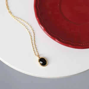 Vintage oval black cat-eye stone necklace in 18K gold plated titanium steel finish