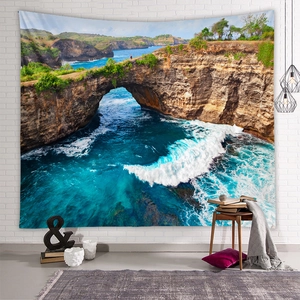 Detail of bohemian ocean landscape tapestry on a white brick wall in a cozy room setting