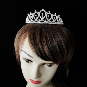Close-up of a silver tiara with sparkling rhinestones on a mannequin head for 30th parties