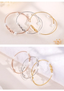Detailopname van de gedraaide titaniumstalen armband met parels en oneindigheidssymbool