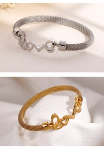 Detailed view of silver and gold mesh bracelets with polished metal Love lettering