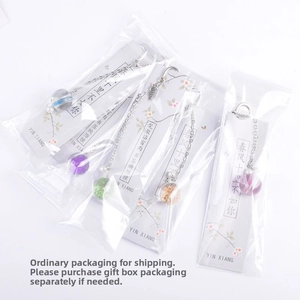 Detail of Chinese style metal feather bookmark with dried flower glass ball pendant