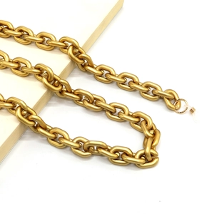 Macro shot of gold matte metal oversized chain links with elastic hooks for glasses