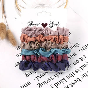 Close-up of 6-piece satin scrunchie set in vintage colors on a Sweet Girl display card