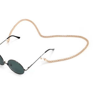 Golden 6mm thick metal corn chain eyewear strap attached to dark round sunglasses