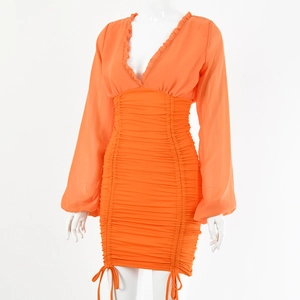 Detail view of orange V-neck mini dress with ruched drawstring sides and sheer sleeves