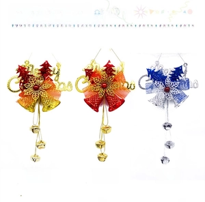 Detailed trio of Merry Christmas twin bell ornaments in gold, red, and silver finishes