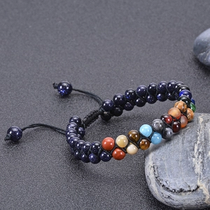 Macro detail of natural blue goldstone beads on a woven double-layer solar system bracelet
