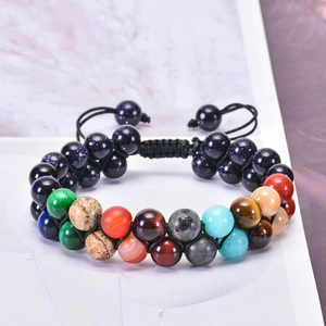 Detail of double-layer woven bracelet with natural colorful stones and adjustable cord