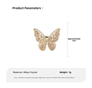 Detail view showing gold butterfly ring dimensions of 3cm and 7g weight with pink zircons