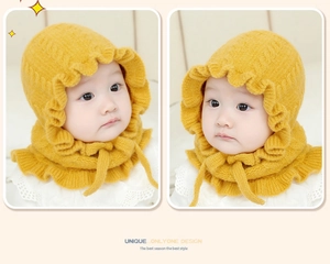 Close-up of baby winter knit hat with yellow frill ruffles and detailed cable knit texture