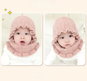 Detail of pink knitted baby hat and scarf set with cute wavy lace edges for winter