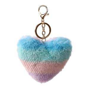 Close-up of heart-shaped plush keychain with pastel gradient fur and golden metal ring