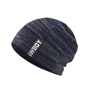 Macro detail of blue-gray knitted beanie texture with SWBOY woven label and rib patterns