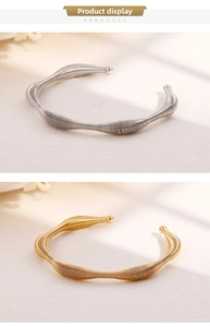 Detail showing spiral texture of gold and silver minimalist open-end metal bracelets