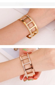 Detail of hollow geometric wide bangle with rhinestones in gold and rose gold