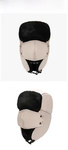 Detail of cream trapper hat with black faux fur lining and detachable face mask cover