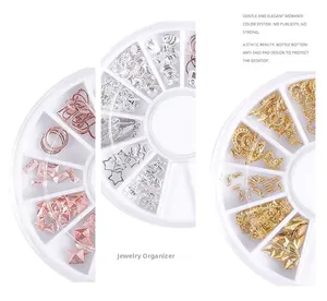 Macro shot of gold, silver, and rose gold nail art studs in a rotating turntable box