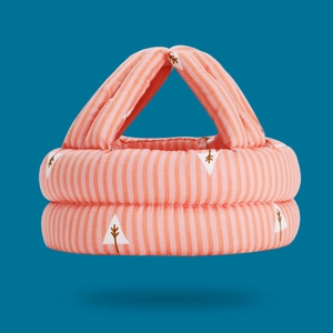 Pink striped baby safety helmet with tree patterns shown from a top-down padded angle
