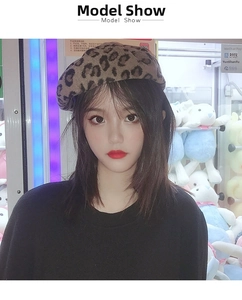 Detailed view of the trendy leopard print beret made of soft wool worn by a fashion model