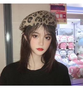 Detailed close-up of a women's leopard print beret made of thick wool fabric for autumn