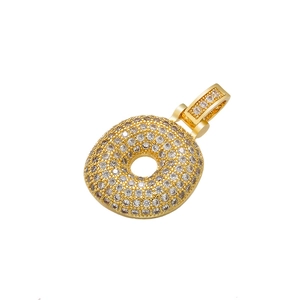 Macro shot of gold donut pendant featuring micro-pave clear cubic zirconia stones