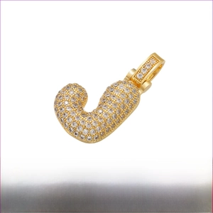 Detailed view of gold plated letter J pendant with micro-pave cubic zirconia stones
