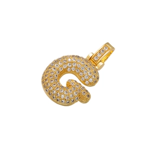 Macro shot of hip hop bubble letter C pendant in gold finish with sparkling crystals