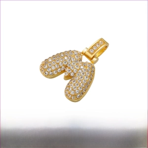 Macro shot of gold plated balloon letter W pendant with sparkling white cubic zirconia stones