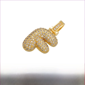 Detail of hip hop letter F pendant in gold brass with white zircon pave setting