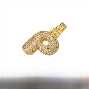 Macro view of gold plated hip hop P letter pendant with micro paved white zircons