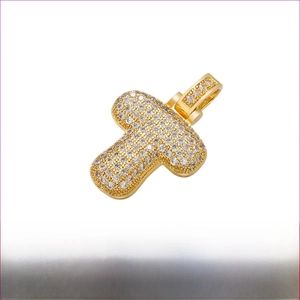 Close-up of gold-plated brass T-letter pendant with sparkling clear cubic zirconia stones