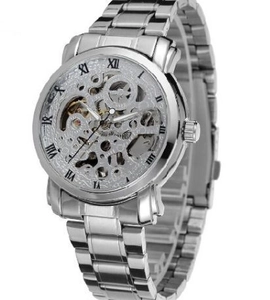 Detailed macro view of silver skeleton dial watch with Roman numerals and steel band