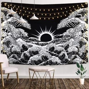 Minimalist black and white wave tapestry decorated with warm string lights in a cozy room