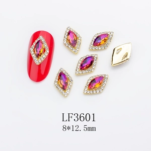 Detail of pink diamond nail charms with gold alloy base and rhinstone settings