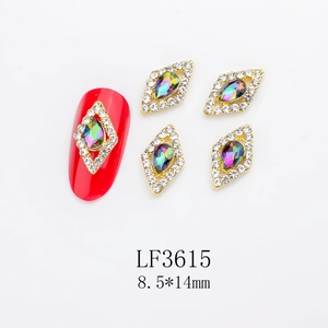 Macro detail of red rhombus nail art charms with AB rhinestones and gold alloy base
