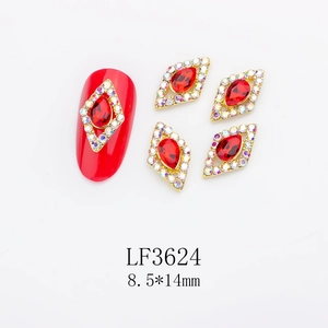 Macro detail of LF3624 red diamond nail charms with gold alloy base and AB crystal accents