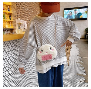 Detailed view of plush rice ball crossbody bag with chain strap and cute face embroidery