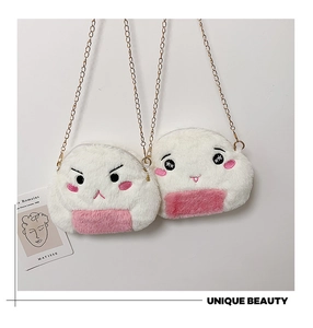 Close-up of onigiri plush bag with embroidery expressions and golden chain strap