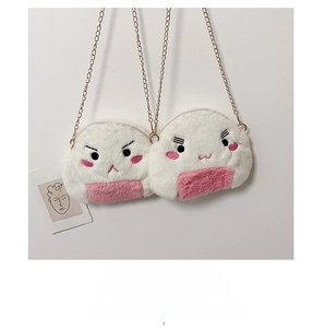 Close-up of white plush rice ball bags with pink accents and golden chains