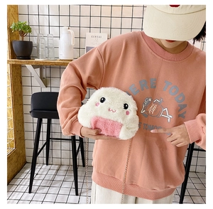 Detailed close-up of plush rice ball bag with embroidery and gold chain strap