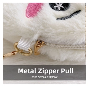 Macro detail of the golden metal zipper pull on a soft white plush shoulder bag