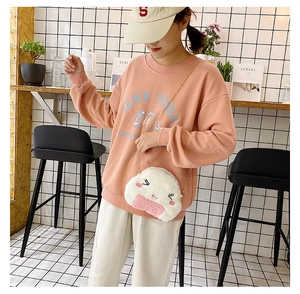 Cute embroidered rice ball plush crossbody bag with gold chain strap on a model