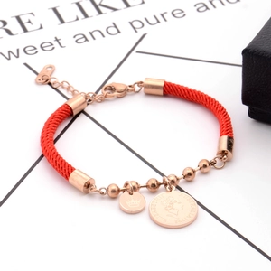 Red braided rope bracelet with rose gold crown and Elizabeth coin charms