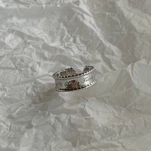 Detailed macro view of silver ring band engraved with Did U Smile Today quote