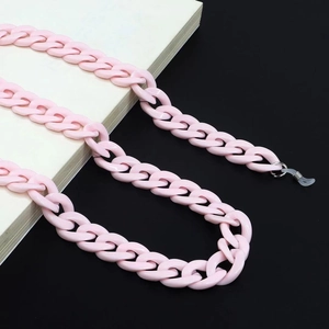 Detailed close-up of pink acrylic eyewear chain with secure silicone loop attachments
