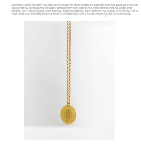 Detail of gold-plated stainless steel necklace with sunburst evil eye pendant charm