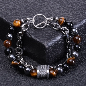 Close-up of tiger eye and black onyx beads with steel chain and T-bar clasp detail
